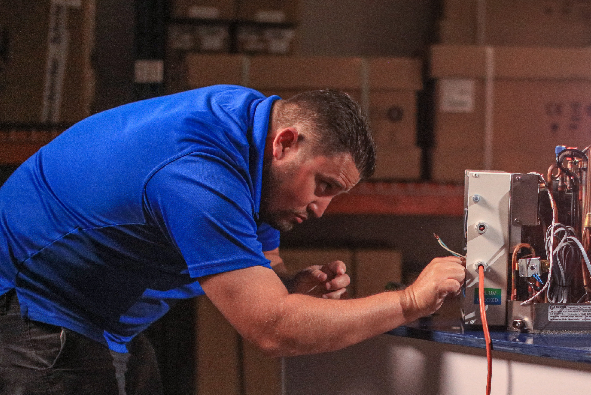 Technician servicing marine air-conditioning equipment